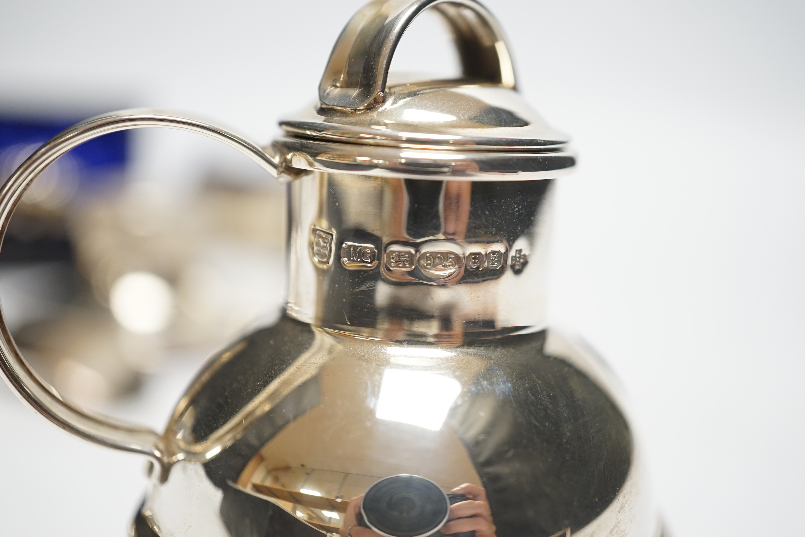 A cased pair of silver salts, one other pair of salts, a Guernsey miniature silver milk jug, an inkwell and two silver sifter ladles.